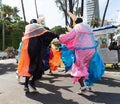 Group of masked people are dancing in the street during the pre-carnival Fuzue parade