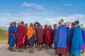 Group of massai warrior stay in the round and participating a traditional dance with high jumps