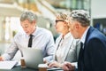 Mature businesspeople sitting in an office having a meeting Royalty Free Stock Photo