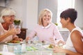 Group Of Mature Female Friends Enjoying Meal At Home