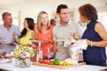 Group Of Mature Friends Enjoying Buffet At Dinner Party