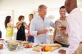 Group Of Mature Friends Enjoying Dinner Party At Home Royalty Free Stock Photo