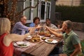 Group Of Mature Friends Enjoying Outdoor Meal In Backyard Royalty Free Stock Photo