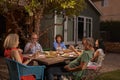 Group Of Mature Friends Enjoying Outdoor Meal In Backyard Royalty Free Stock Photo