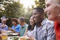 Group Of Mature Friends Enjoying Outdoor Meal In Backyard Royalty Free Stock Photo