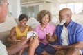 Group Of Mature Friends At Home Having Fun Playing Cards Together Royalty Free Stock Photo