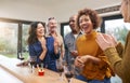 Group Of Mature Friends Meeting At Home To Celebrate Womans Birthday With Cake Royalty Free Stock Photo