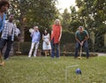 Group Of Mature Friends Playing Croquet In Backyard Together Royalty Free Stock Photo