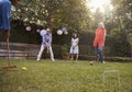 Group Of Mature Friends Playing Croquet In Backyard Together Royalty Free Stock Photo