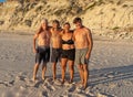 Group of mature happy active adults having fun in the beach. Long time friends Royalty Free Stock Photo