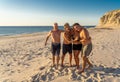 Group of mature happy active adults having fun in the beach. Long time friends Royalty Free Stock Photo