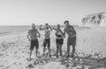 Group of mature happy active adults having fun in the beach. Long time friends Royalty Free Stock Photo