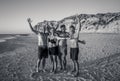 Group of mature happy active adults having fun in the beach. Long time friends Royalty Free Stock Photo