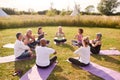 Group Of Mature Men And Women In Class At Outdoor Yoga Retreat Sitting Circle Meditating Royalty Free Stock Photo