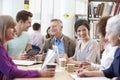 Group Of Mature Students Collaborating On Project In Library Royalty Free Stock Photo