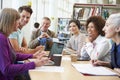 Group Of Mature Students Collaborating On Project In Library Royalty Free Stock Photo