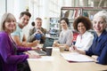 Group Of Mature Students Collaborating On Project In Library Royalty Free Stock Photo