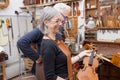 Group of mature violin maker in pose Royalty Free Stock Photo