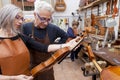 Group of mature violin maker in pose Royalty Free Stock Photo