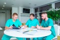 Group of medical staff discussing patient results in clinic. Healthcare professionals having discussion in hospital. Experienced