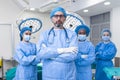 Group of medical surgeons wearing hospital scrubs in operating theatre. Portrait of successful medical workers in surgical uniform Royalty Free Stock Photo