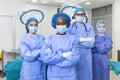 Group of medical surgeons wearing hospital scrubs in operating theatre. Portrait of successful medical workers in surgical uniform Royalty Free Stock Photo