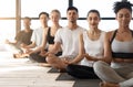 Group Meditation. Sporty Multiracial Men And Women Meditating Together During Yoga Class Royalty Free Stock Photo