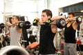 Group of men with barbells in gym