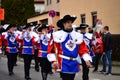 Group of men in blue and red troubadour costumes playing flutes and parading on the German Carnival
