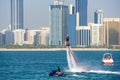 Group of men doing water sports in front of skyline taken on March 31, 2013 in Abu Dhabi, United Arab