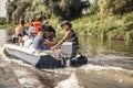 Group of men sailing on motor boat by river to the hunting camp during hunting season Royalty Free Stock Photo