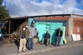 group of men walk on the street in Khayelitsha township