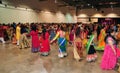 Group of Men and women are dancing and enjoying Hindu festival of Navratri Garba wearing traditional consume.