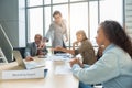 Group of men and women having casual discussion during meeting sitting in office Royalty Free Stock Photo