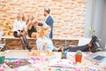 A group of men and women working in the office, eating pizza in a festive mood. Close-up of a girl with a pizza put her Royalty Free Stock Photo