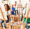 Group of middle age draw students smiling happy drawing at art studio Royalty Free Stock Photo