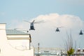 A group of military helicopter flies in the sky