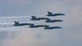 Group of military jets flying in formation across the sky