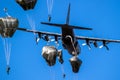 Group of military parachutist paratroopers jumping out of a transport plane during the Operation Market Garden memorial