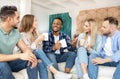 Group of millennial diverse friends chatting, having fun student party, spending weekend together at home Royalty Free Stock Photo