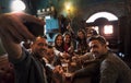 Group of millennial people takes a selfie in a pub drinking beer