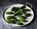 A group of mini avocado on a serving tray isolated on dark background. Seedles green food for healthy lifestyle Royalty Free Stock Photo