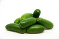 A group of mini avocado stacked to a pyramid on white background.