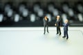 Group of miniature people businessmen collaborate help and work as team Royalty Free Stock Photo