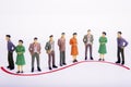 Group of miniature people over white background standing in line Royalty Free Stock Photo