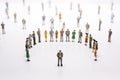 Group of miniature people over white background standing in line Royalty Free Stock Photo