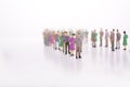 Group of miniature people over white background standing in line Royalty Free Stock Photo