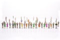 Group of miniature people over white background standing in line Royalty Free Stock Photo