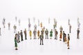 Group of miniature people over white background standing in line Royalty Free Stock Photo