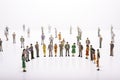 Group of miniature people over white background standing in line Royalty Free Stock Photo